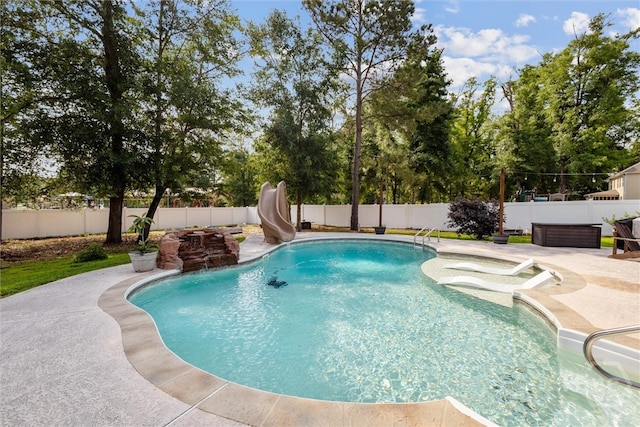 110 Vintage Dr, Guyton, GA 31312 - view of swimming pool with a water slide, a fenced backyard, and a patio