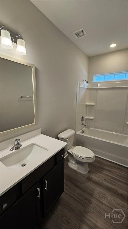 182 Brookline Dr, Savannah, GA 31407 - bathroom with toilet, washtub / shower combination, vanity, wood finished floors, and recessed lighting