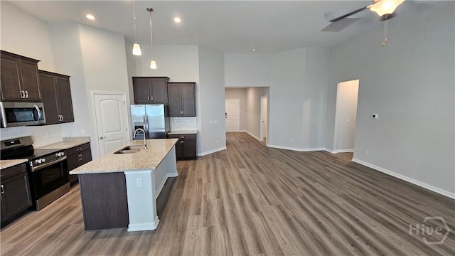182 Brookline Dr, Savannah, GA 31407 - kitchen featuring stainless steel appliances, a sink, a high ceiling, backsplash, and dark brown cabinets
