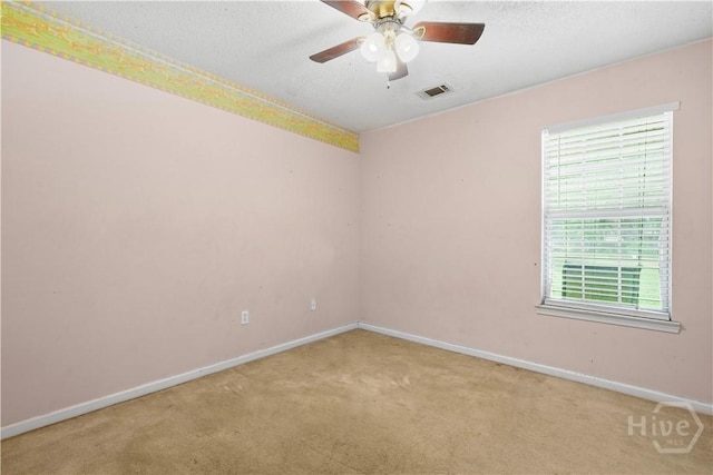 115 Ashley Dr, Guyton, GA 31312 - spare room with baseboards, light colored carpet, a ceiling fan, and a textured ceiling