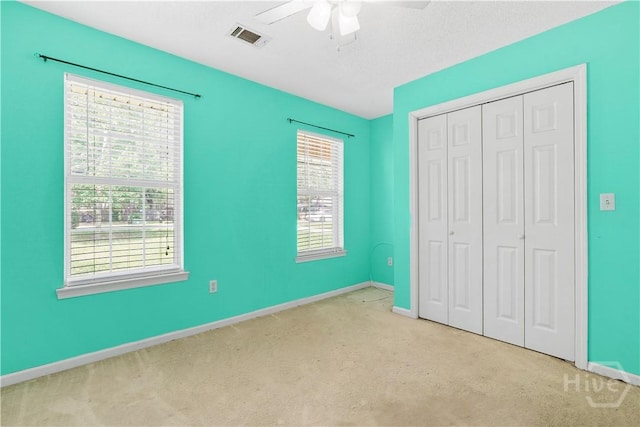 115 Ashley Dr, Guyton, GA 31312 - unfurnished bedroom with a closet, carpet flooring, baseboards, and a ceiling fan