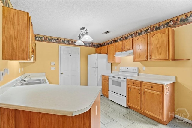115 Ashley Dr, Guyton, GA 31312 - kitchen with white appliances, under cabinet range hood, a sink, light countertops, and a textured ceiling