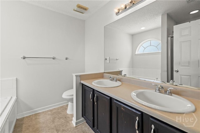 25 Ashley Ct, Richmond Hill, GA 31324 - full bathroom with a garden tub, toilet, double vanity, baseboards, and a textured ceiling