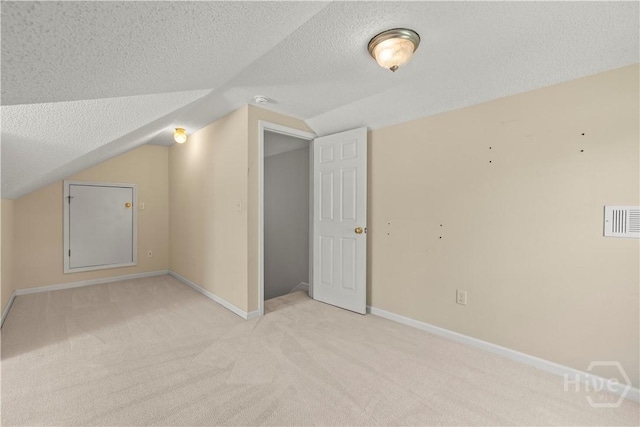 25 Ashley Ct, Richmond Hill, GA 31324 - additional living space featuring vaulted ceiling, light carpet, a textured ceiling, and baseboards