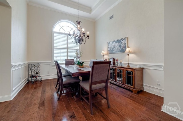 354 Brown Thrush Rd, Savannah, GA 31419 - dining room featuring a chandelier, crown molding, wood finished floors, a tray ceiling, and wainscoting