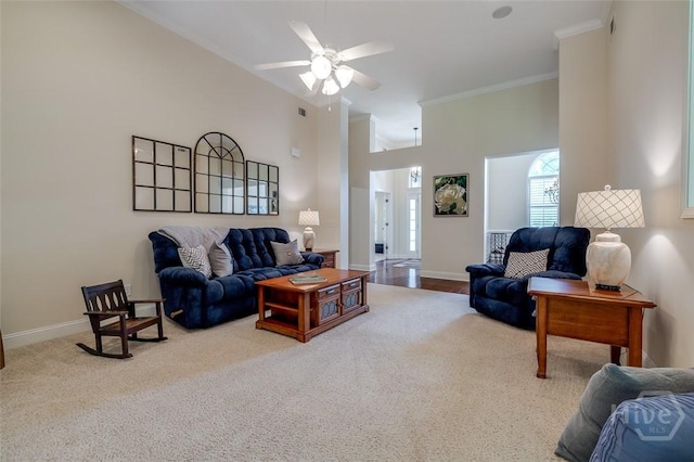 354 Brown Thrush Rd, Savannah, GA 31419 - living area with ornamental molding, carpet floors, a ceiling fan, baseboards, and a towering ceiling