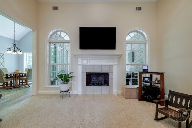 354 Brown Thrush Rd, Savannah, GA 31419 - carpeted living area with healthy amount of natural light, a fireplace, a chandelier, high vaulted ceiling, and baseboards