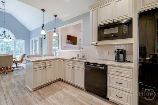 354 Brown Thrush Rd, Savannah, GA 31419 - kitchen with black appliances, cream cabinets, a sink, vaulted ceiling, and tasteful backsplash