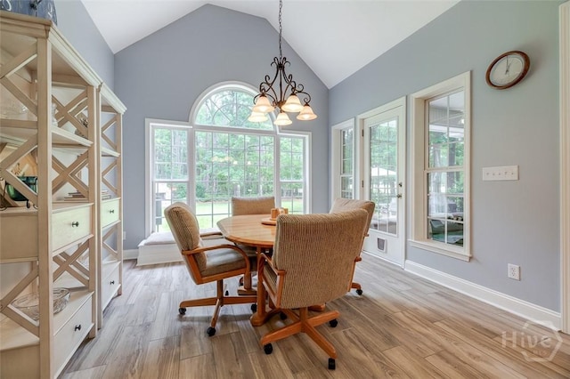 354 Brown Thrush Rd, Savannah, GA 31419 - dining space featuring lofted ceiling, light wood finished floors, a chandelier, and baseboards
