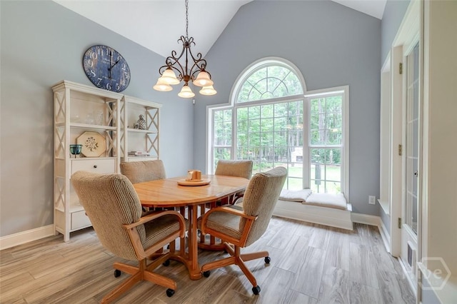 354 Brown Thrush Rd, Savannah, GA 31419 - dining area featuring light wood-style floors, a chandelier, high vaulted ceiling, and baseboards