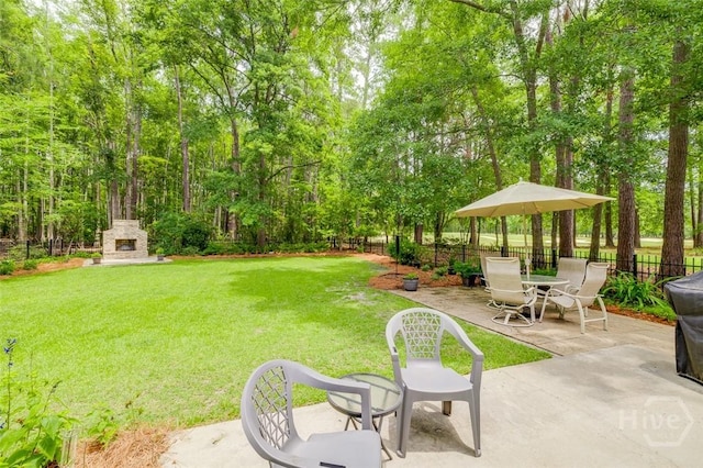 354 Brown Thrush Rd, Savannah, GA 31419 - view of yard featuring an outdoor stone fireplace and a patio area