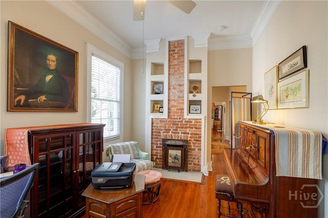 120 Brady St, Savannah, GA 31401 - living area featuring ornamental molding, wood finished floors, ceiling fan, a fireplace, and built in shelves