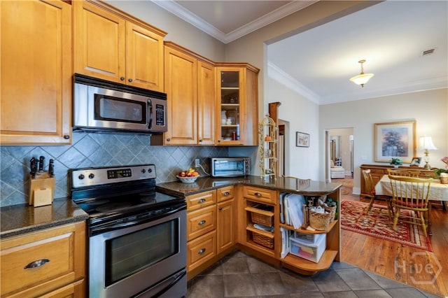 120 Brady St, Savannah, GA 31401 - kitchen with stainless steel appliances, crown molding, backsplash, glass insert cabinets, and dark stone counters