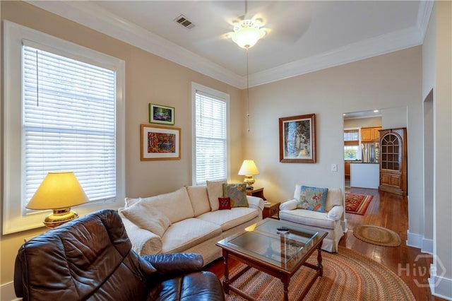 120 Brady St, Savannah, GA 31401 - living area with wood finished floors, ornamental molding, ceiling fan, and baseboards