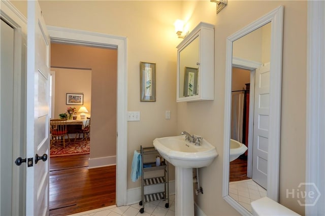 120 Brady St, Savannah, GA 31401 - bathroom featuring baseboards and wood finished floors
