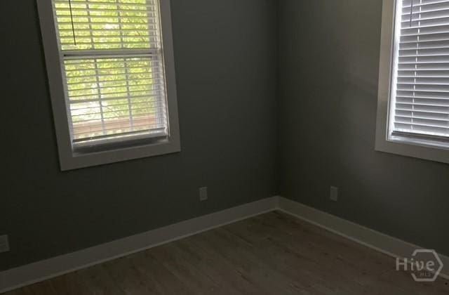 716 W 51st St, Savannah, GA 31405 - spare room featuring baseboards and dark wood-style floors