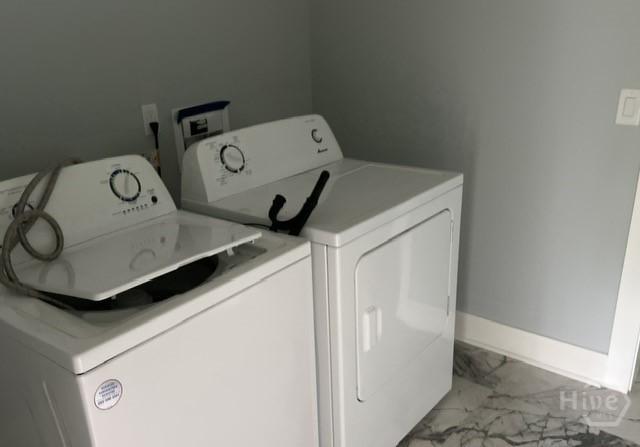 716 W 51st St, Savannah, GA 31405 - laundry room featuring washer and dryer, marble finish floors, and baseboards