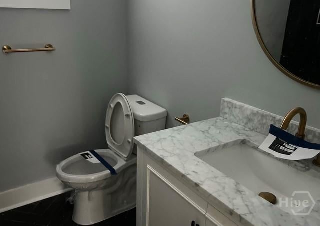 716 W 51st St, Savannah, GA 31405 - bathroom featuring toilet, vanity, and baseboards