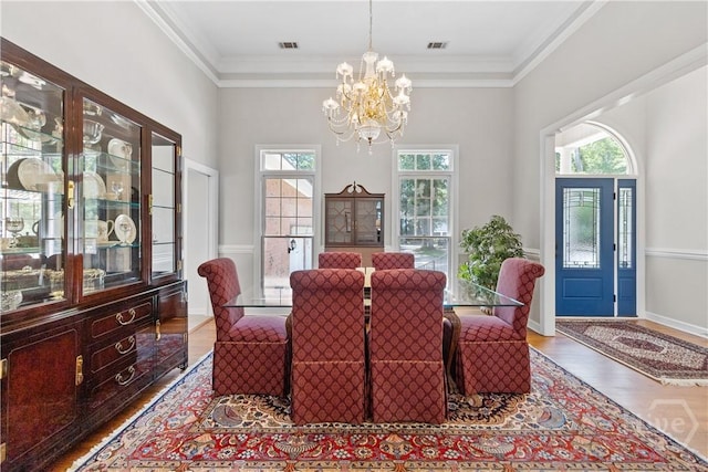 245 Montauk Dr, Richmond Hill, GA 31324 - dining area with a chandelier, wood finished floors, and ornamental molding