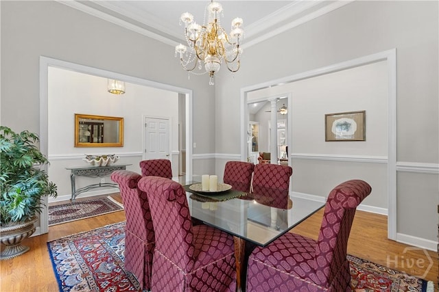 245 Montauk Dr, Richmond Hill, GA 31324 - dining area with a chandelier, crown molding, and wood finished floors