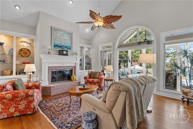 245 Montauk Dr, Richmond Hill, GA 31324 - living area featuring built in features, wood finished floors, a ceiling fan, a fireplace, and recessed lighting