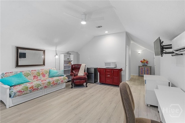 245 Montauk Dr, Richmond Hill, GA 31324 - living area featuring lofted ceiling, light wood-style floors, a ceiling fan, and a wall mounted AC