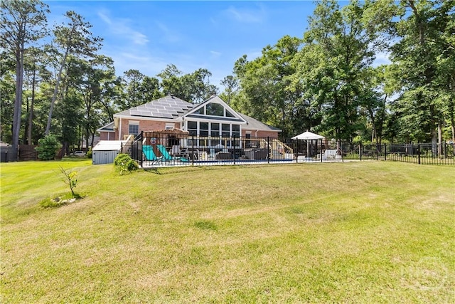 245 Montauk Dr, Richmond Hill, GA 31324 - rear view of house featuring brick siding and a playground