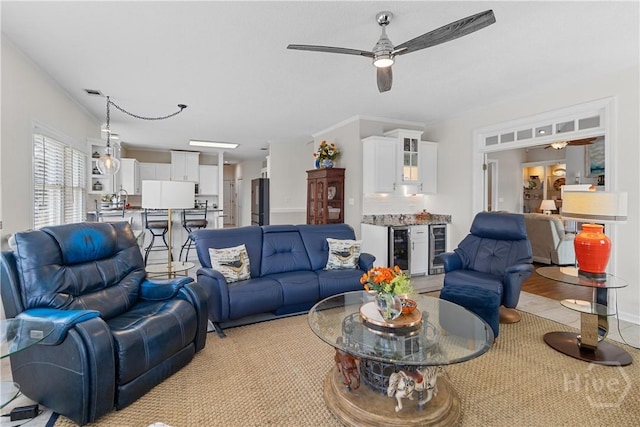 245 Montauk Dr, Richmond Hill, GA 31324 - living area featuring a ceiling fan, wine cooler, and crown molding