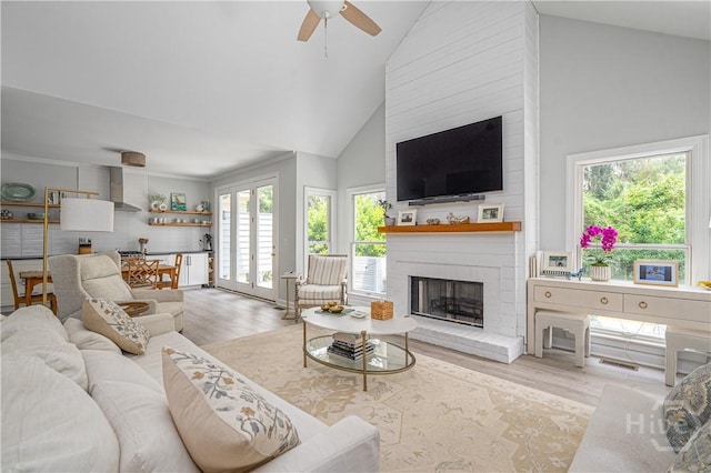 22 Sparnel Rd, Savannah, GA 31411 - living area with healthy amount of natural light, wood finished floors, a brick fireplace, and high vaulted ceiling