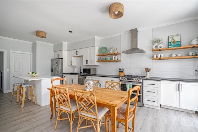 22 Sparnel Rd, Savannah, GA 31411 - kitchen featuring wall chimney range hood, stainless steel appliances, open shelves, ornamental molding, and light wood-style flooring