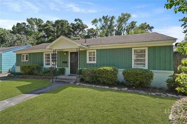 355 Riverview Dr, Savannah, GA 31404 - ranch-style house with a front yard, board and batten siding, a shingled roof, and brick siding