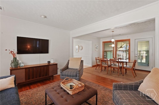 355 Riverview Dr, Savannah, GA 31404 - living area with wood finished floors, a textured ceiling, and crown molding