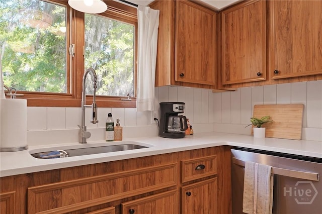 355 Riverview Dr, Savannah, GA 31404 - kitchen with dishwasher, a sink, brown cabinets, decorative backsplash, and light countertops