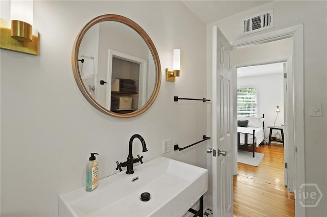 355 Riverview Dr, Savannah, GA 31404 - bathroom featuring a sink and wood finished floors