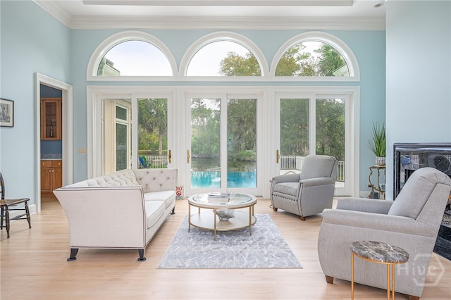 4 Longwater Ln, Savannah, GA 31411 - living room with crown molding, light wood-style flooring, and a towering ceiling