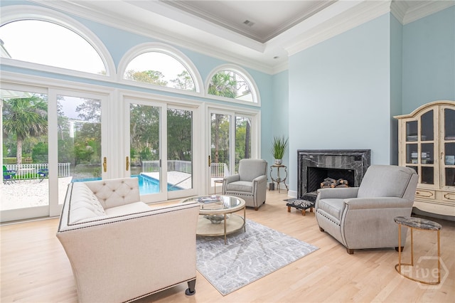 4 Longwater Ln, Savannah, GA 31411 - living area featuring a high end fireplace, light wood-type flooring, crown molding, and a towering ceiling