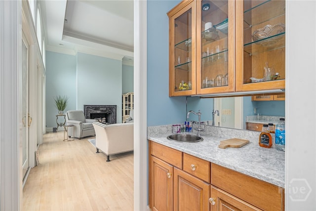 4 Longwater Ln, Savannah, GA 31411 - indoor wet bar featuring ornamental molding, a fireplace, and light wood-type flooring