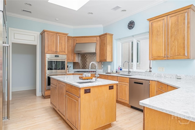 4 Longwater Ln, Savannah, GA 31411 - kitchen featuring appliances with stainless steel finishes, a sink, light wood finished floors, a skylight, and crown molding