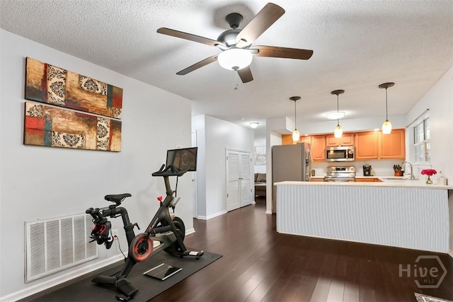 125 Penn Sta, Savannah, GA 31410 - kitchen with stainless steel appliances, a sink, a ceiling fan, a peninsula, and light countertops