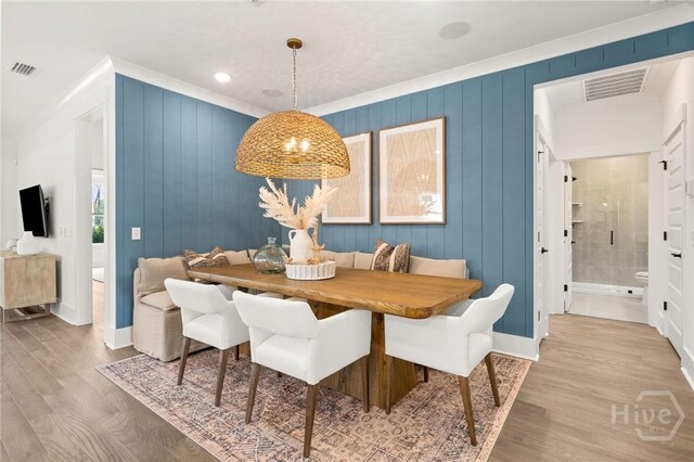 333 Birch Dr, Richmond Hill, GA 31324 - dining space with wood finished floors, crown molding, and baseboards
