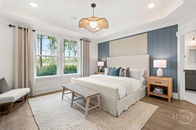 333 Birch Dr, Richmond Hill, GA 31324 - bedroom featuring a tray ceiling, light wood-type flooring, and baseboards
