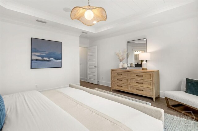 333 Birch Dr, Richmond Hill, GA 31324 - bedroom featuring wood finished floors, a raised ceiling, and baseboards