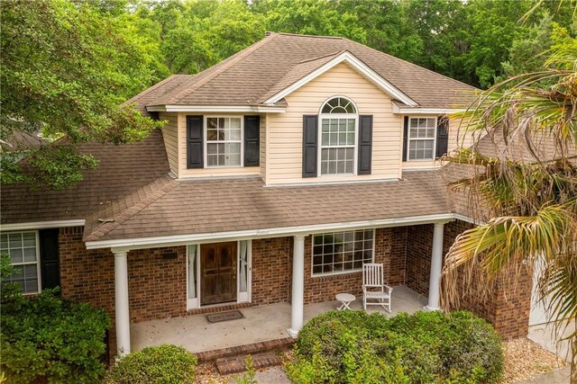 205 Meadowlark Cir, Savannah, GA 31419 - shingle-style home featuring a shingled roof, brick siding, and a patio
