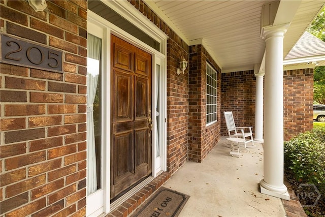 205 Meadowlark Cir, Savannah, GA 31419 - doorway to property featuring a porch and brick siding