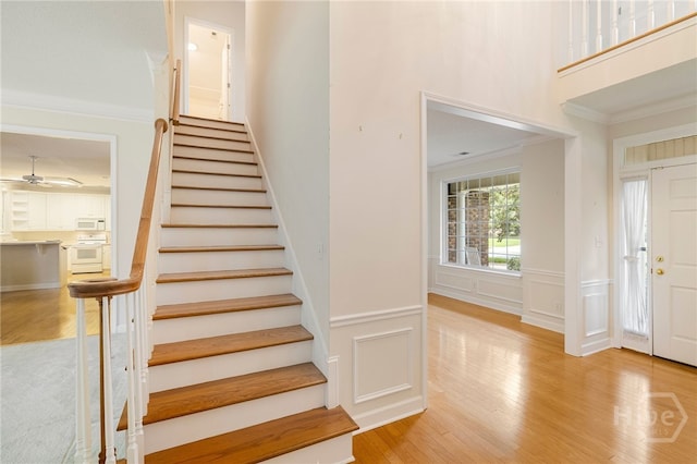 205 Meadowlark Cir, Savannah, GA 31419 - stairway with wood finished floors, ornamental molding, ceiling fan, a decorative wall, and a wainscoted wall