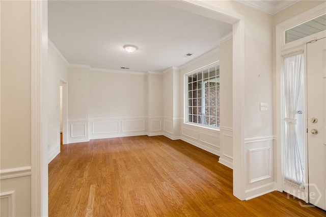 205 Meadowlark Cir, Savannah, GA 31419 - spare room featuring a decorative wall, ornamental molding, wood finished floors, and a wainscoted wall
