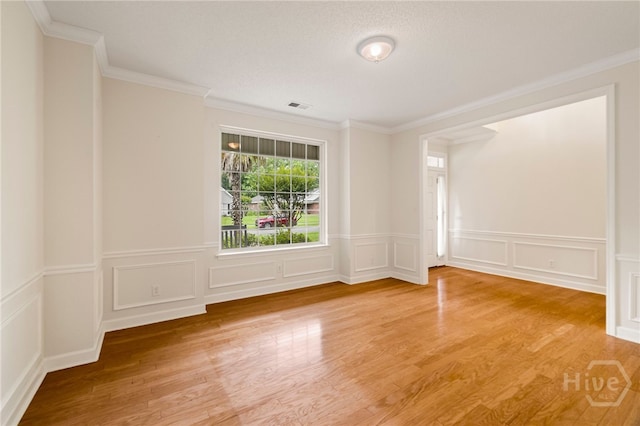 205 Meadowlark Cir, Savannah, GA 31419 - empty room featuring light wood-style floors, ornamental molding, a decorative wall, and wainscoting