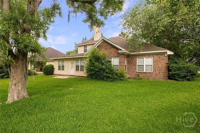 205 Meadowlark Cir, Savannah, GA 31419 - view of front facade featuring a chimney, a front yard, brick siding, and a patio