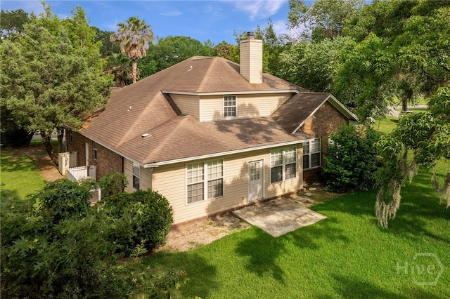 205 Meadowlark Cir, Savannah, GA 31419 - rear view of property with a chimney, a lawn, and view of wooded area