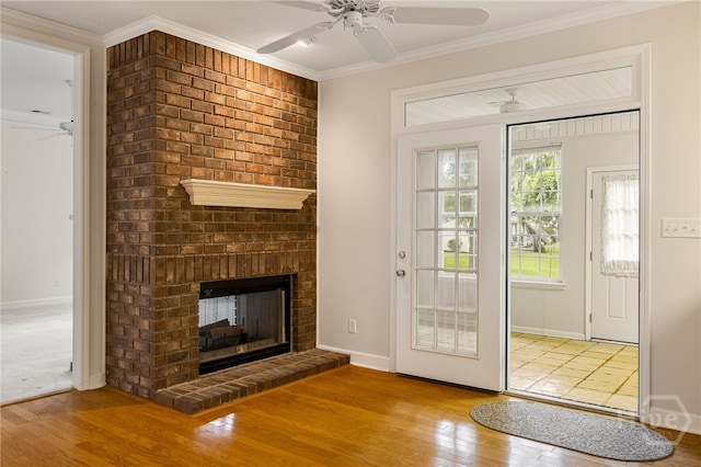 205 Meadowlark Cir, Savannah, GA 31419 - unfurnished living room featuring a ceiling fan, wood finished floors, a fireplace, and crown molding
